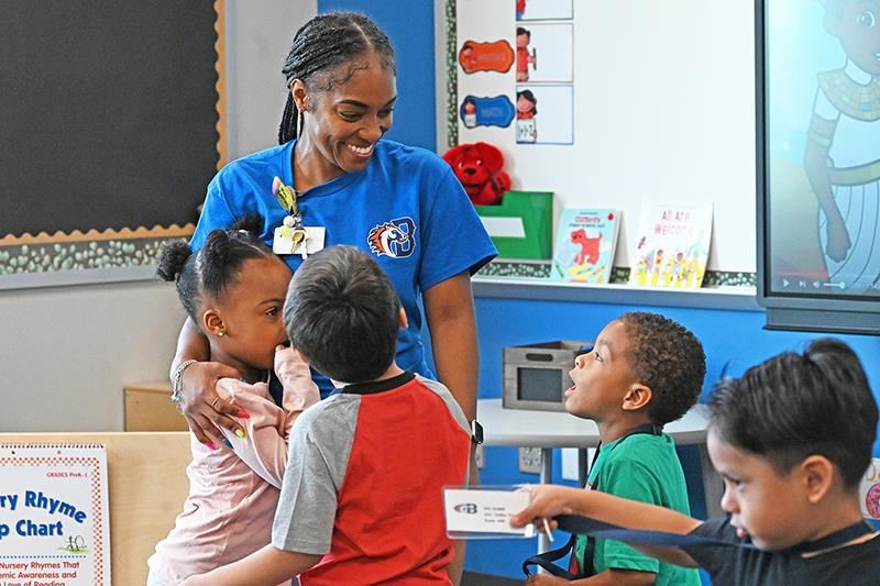 Brosnahan Elementary School Pre-K teacher Heather Settles welcomes students to her class on the first day of school.